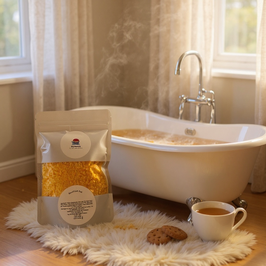 A packaged bag of Bath dust by a bath tub with a mug and biscuits.