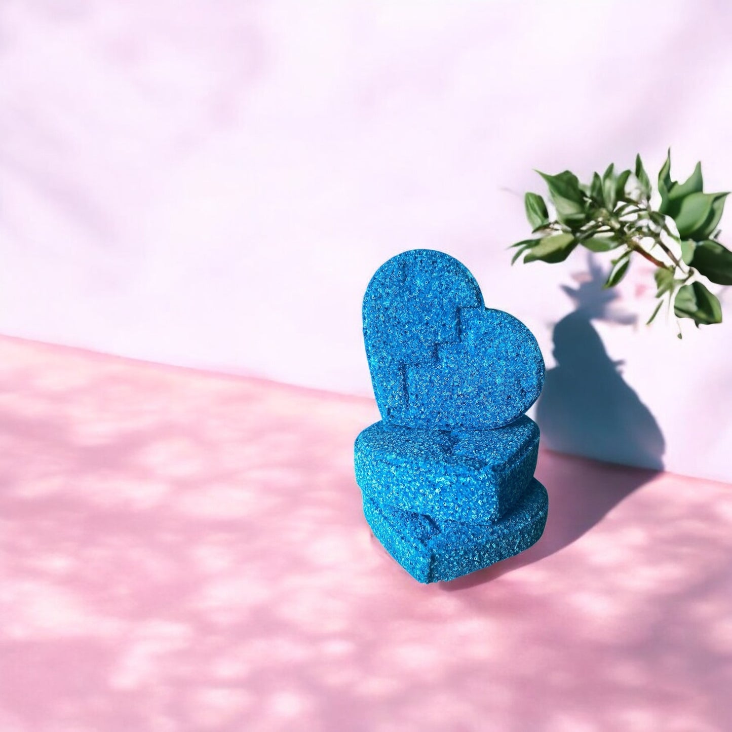 A handmade sapphire blue heart shaped bubblegum scented bath bomb