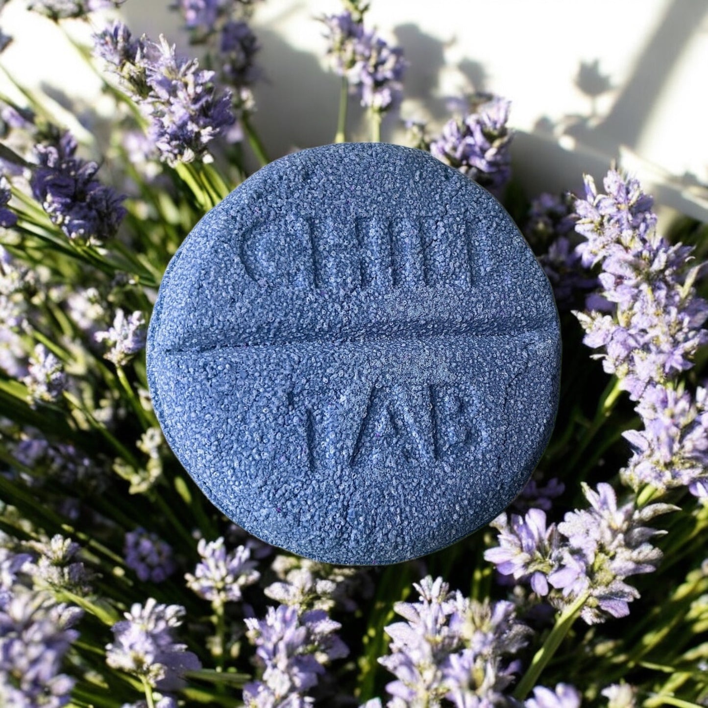 A lavender scented violet coloured chill tab shaped handmade Bath bomb