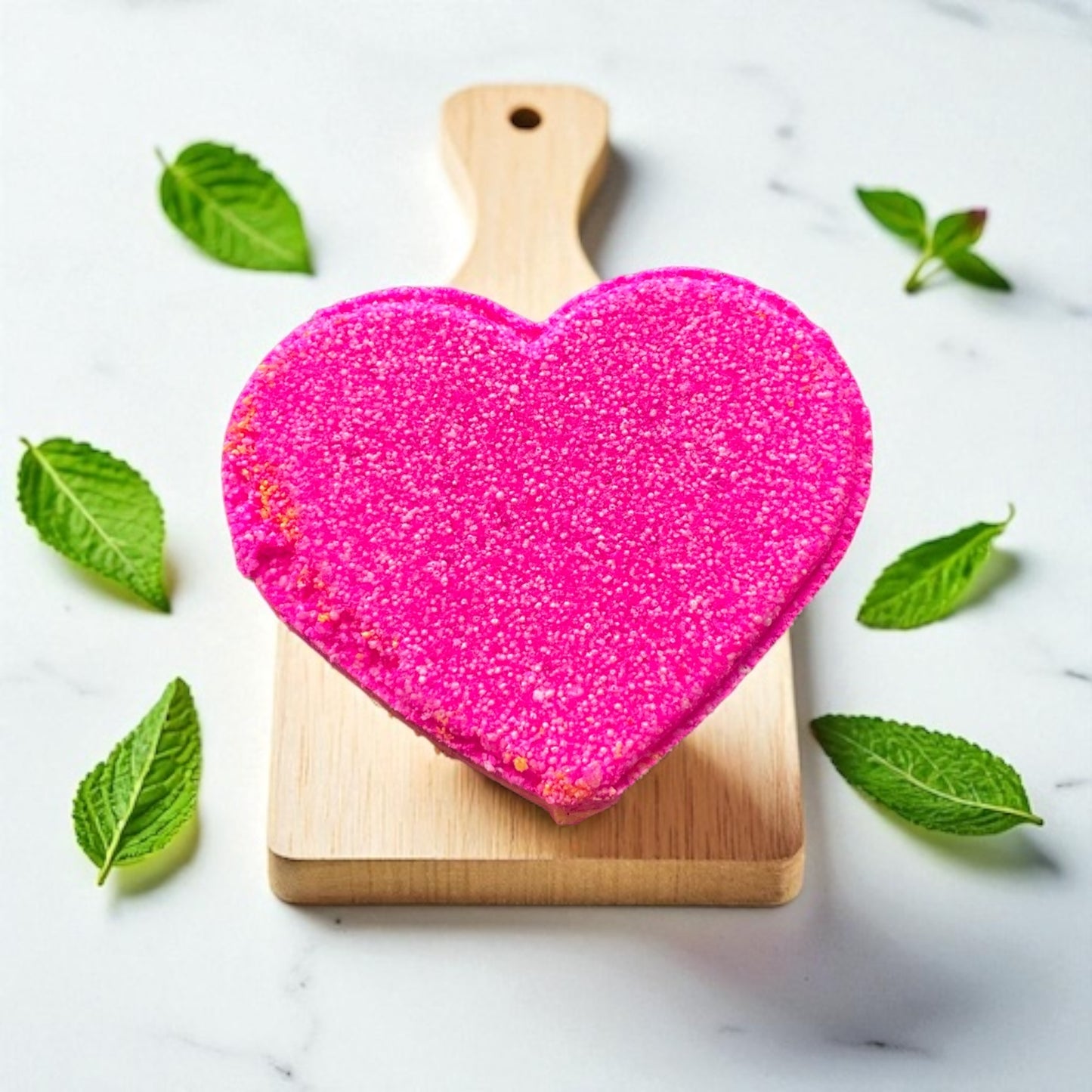 A handmade rhubarb and custard scented pink and yellow bath bomb