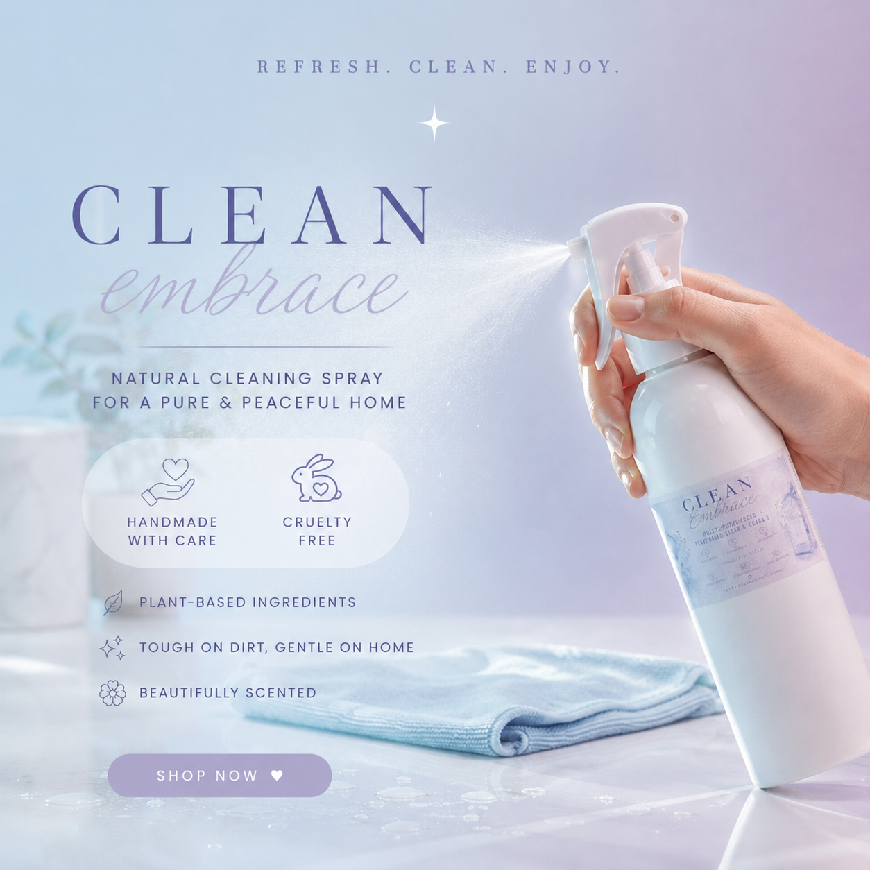 A hand holds a white spray bottle of CLEAN embrace natural cleaning spray, spraying a fine mist onto a light blue cloth on a pale lavender surface. Text on the image highlights natural cleaning spray benefits, with the brand name CLEAN embrace visible on the bottle.