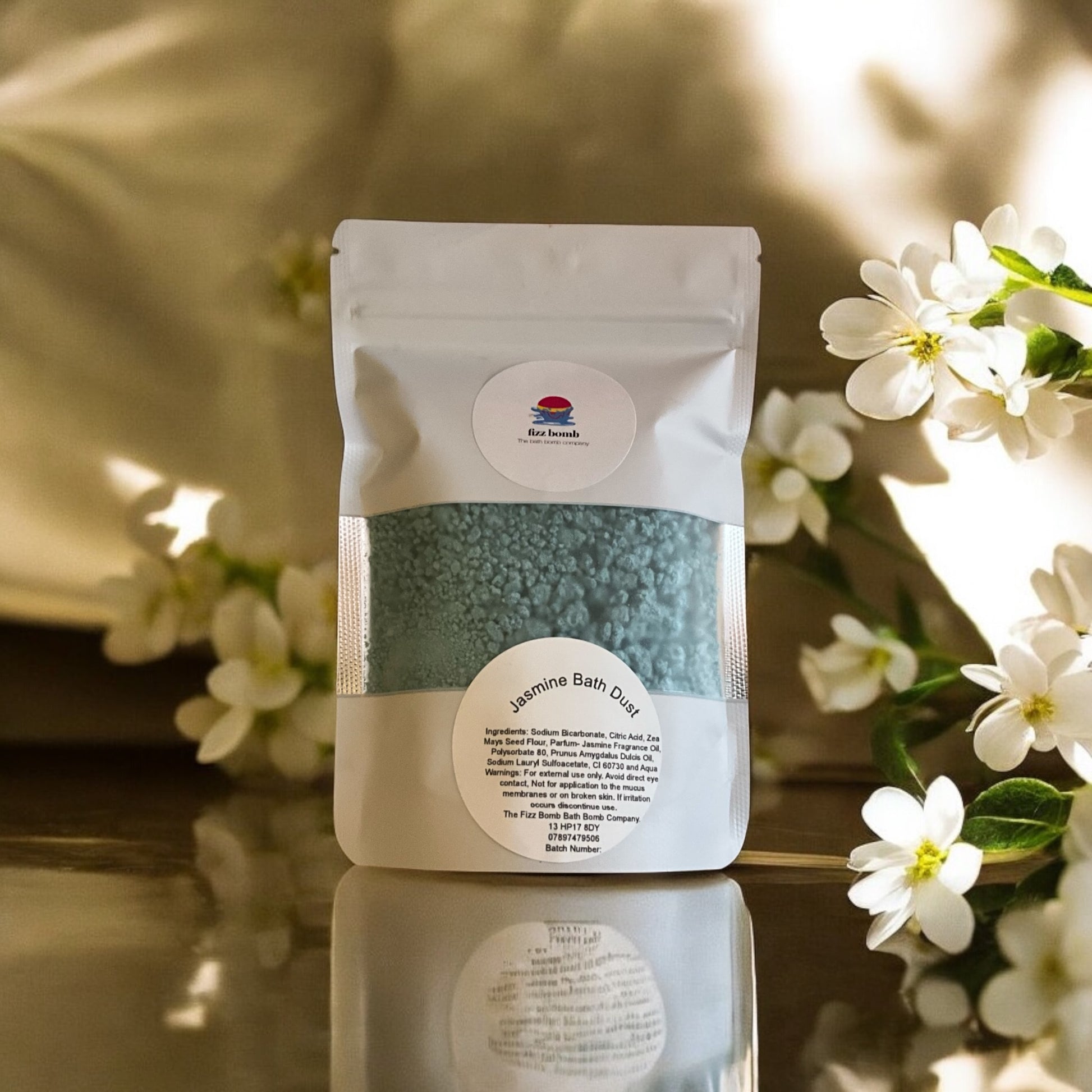 A bag of teal coloured jasmine scented bath dust. 