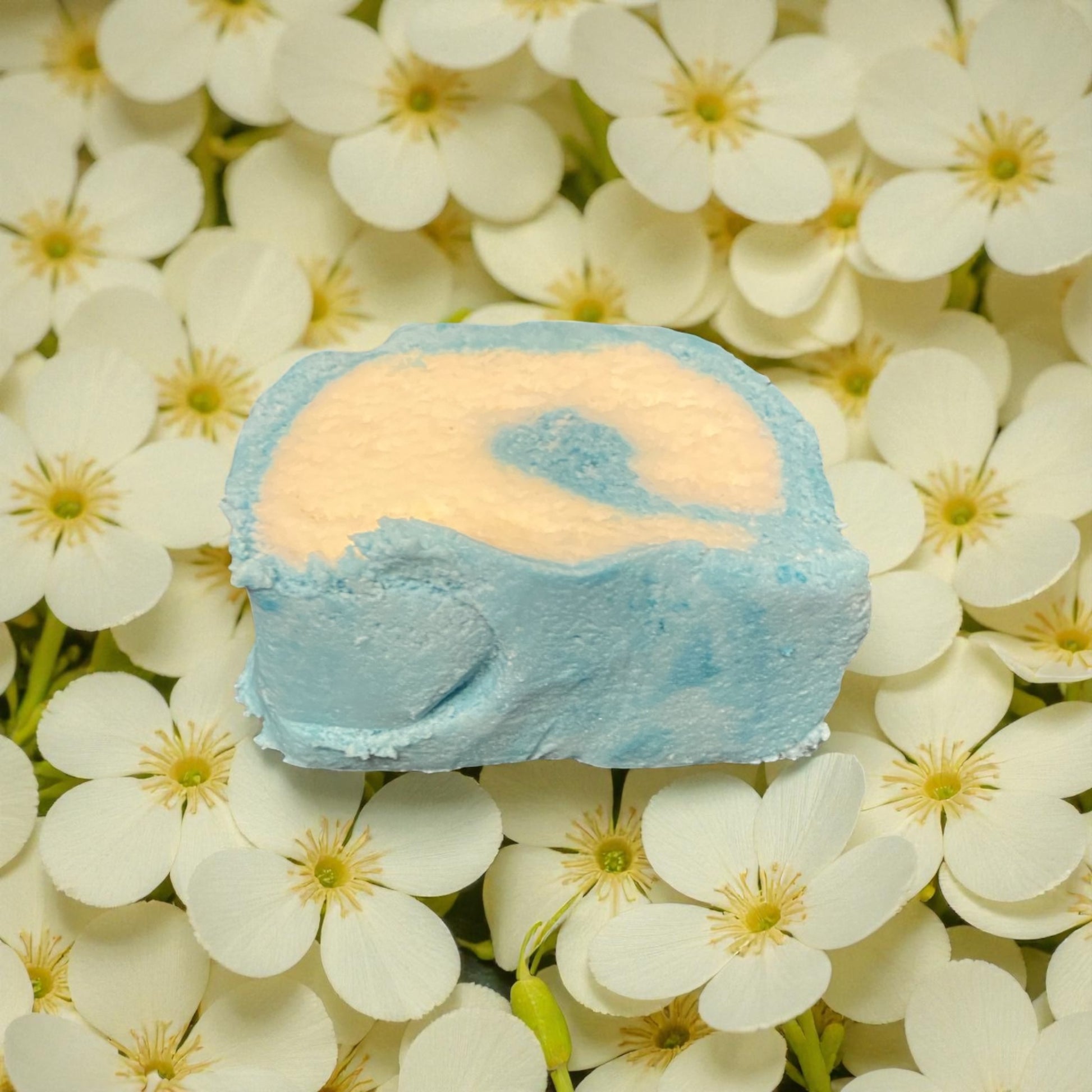 A Jasmine scented teal and white bubble bar with a Jasmine flowers background