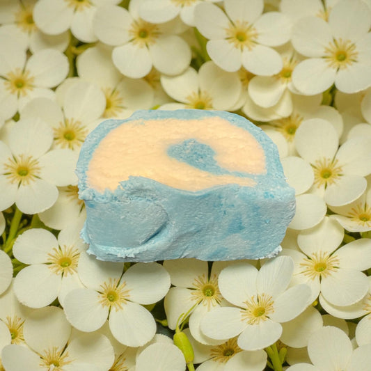 A Jasmine scented teal and white bubble bar with a Jasmine flowers background