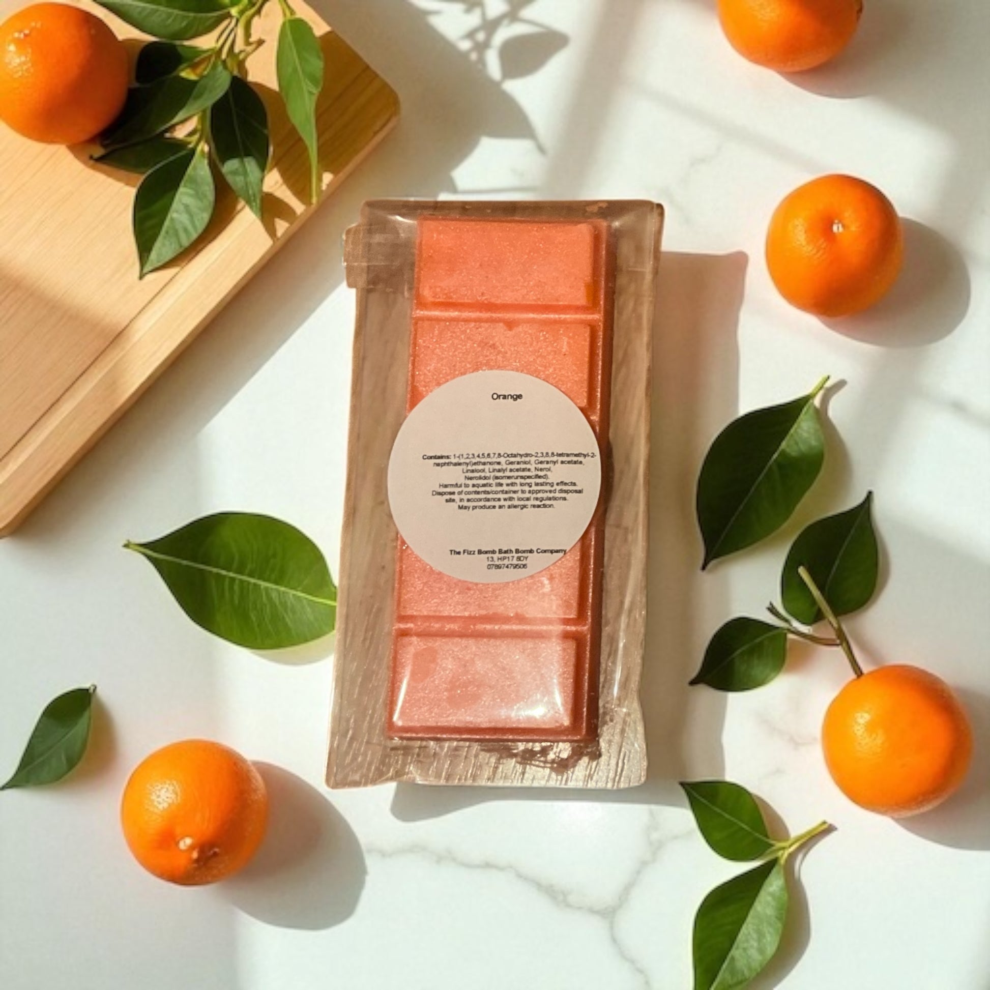 A handmade orange coloured orange scented wax melt