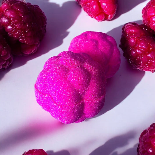 A handmade hot pink coloured, raspberry scented, berry shaped bath bomb