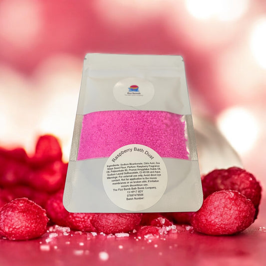 A bag of handmade hot pink raspberry Bath dust with a raspberries background