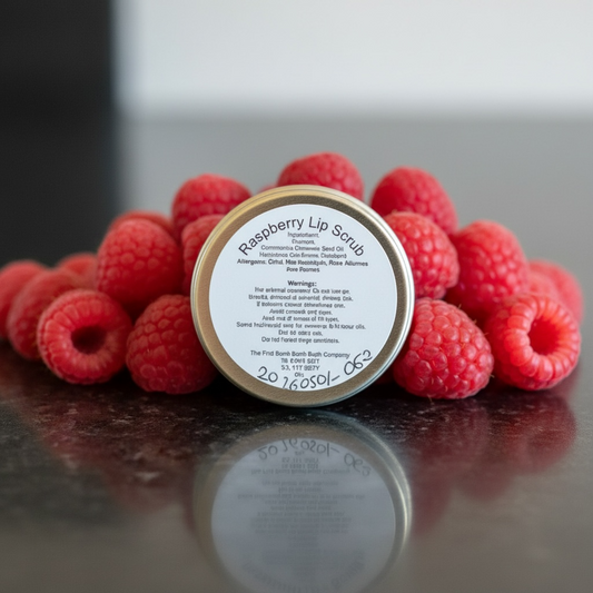 A tin of lip scrub with a raspberries background