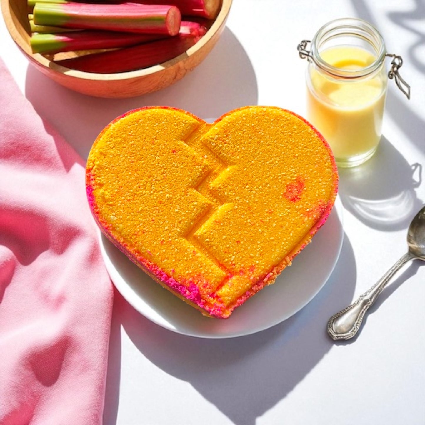 A handmade rhubarb and custard scented yellow and pink coloured bath bomb