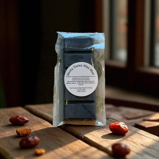 Wax melt packaging on a wooden surface with dates